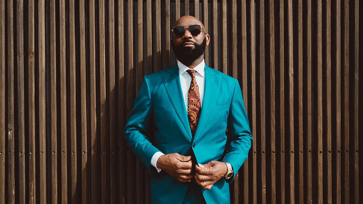 An attractive bald man in blue suit